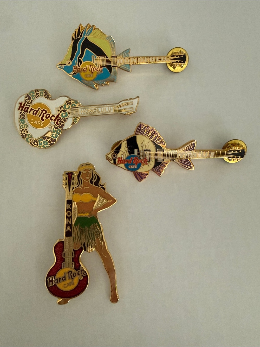 Lot of 4 Hawaiian-themed Hard Rock Cafe pins guitars, tropical fish, hula girl